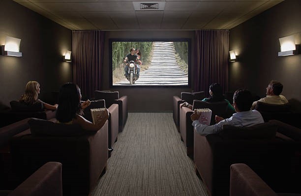 A home theater with seats on either side of an aisle